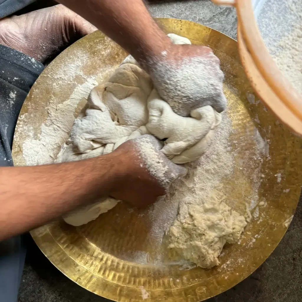 pessoa sovando massa de pão